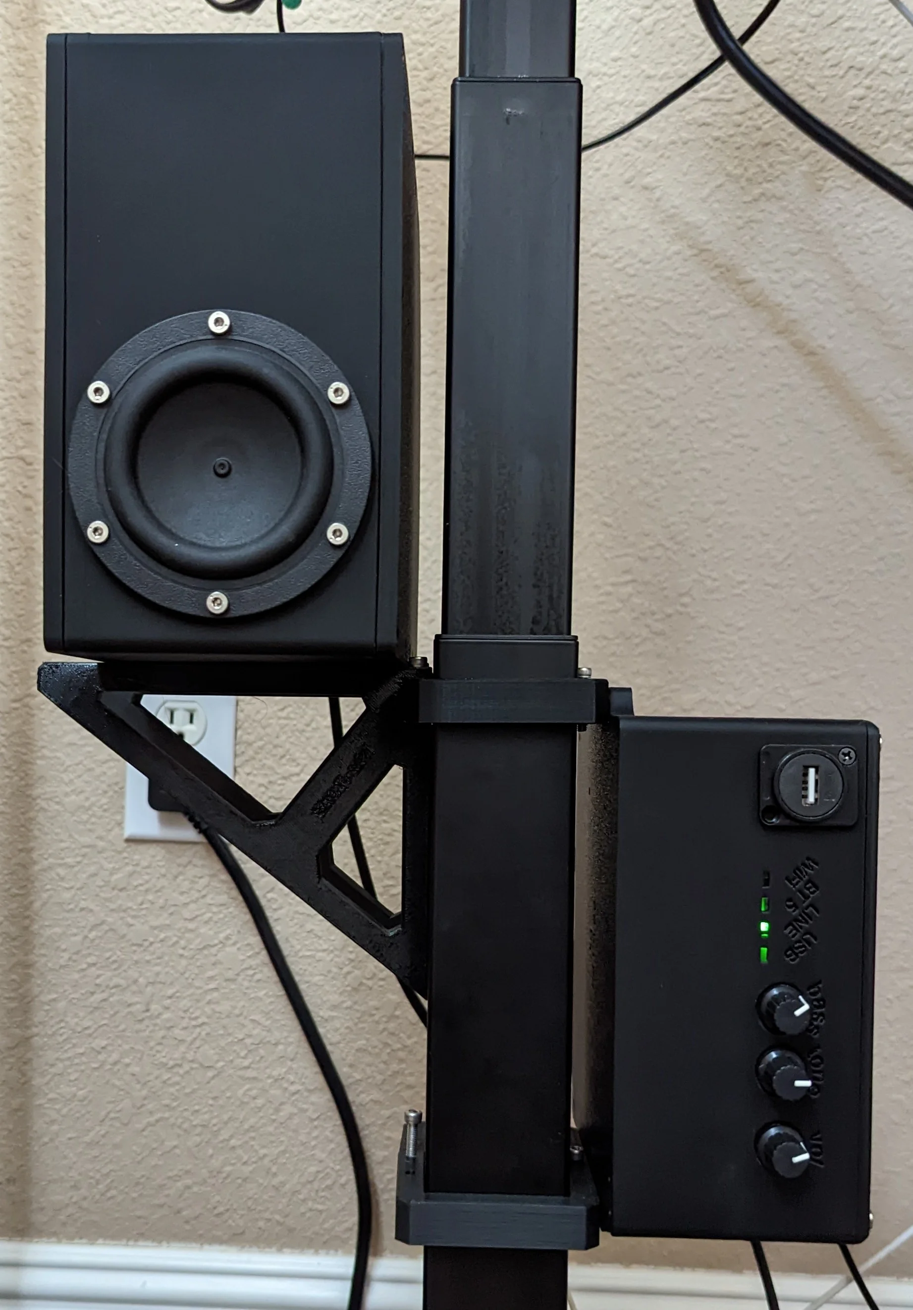 Subwoofer and amp enclosure mounted to the leg of my desk. Please ignore the mess of wires in the background!