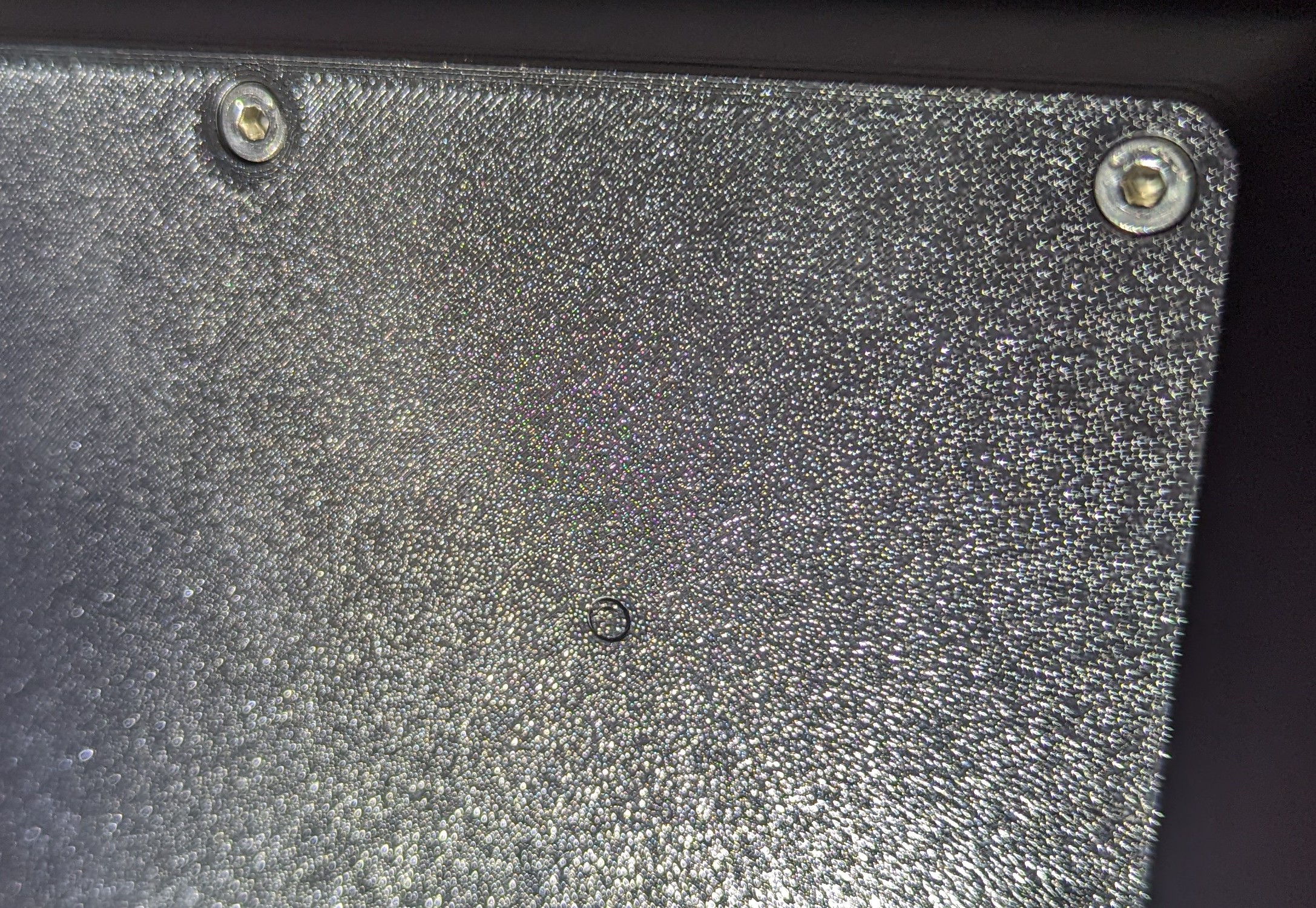 Picture showing close up of subwoofer panel; the hole meant for VESA mounting is almost invisible as it's full of support material.
