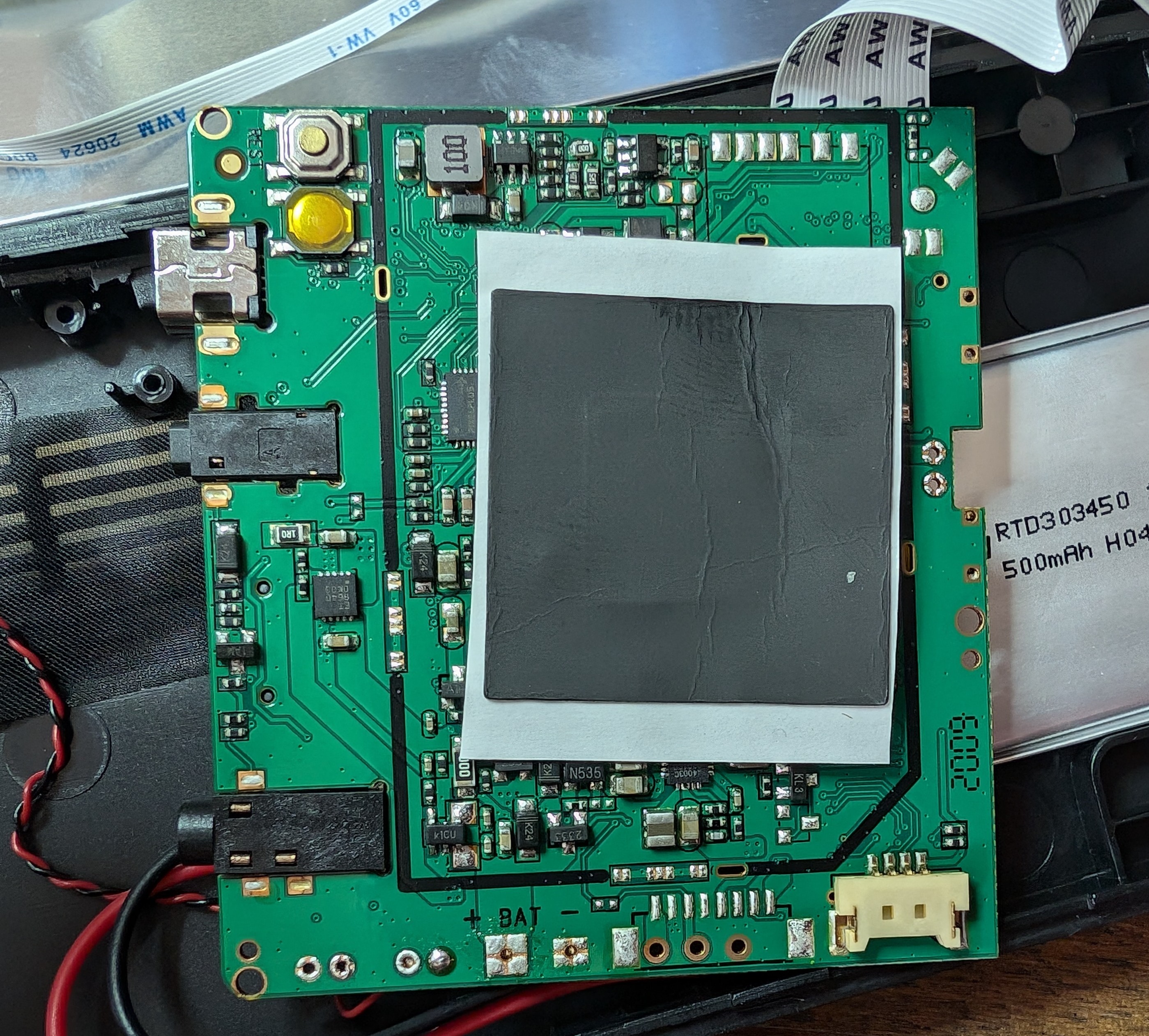 The 'rear' of the main PCB has a few unpopulated footprints and a flimsy heat-spreader.