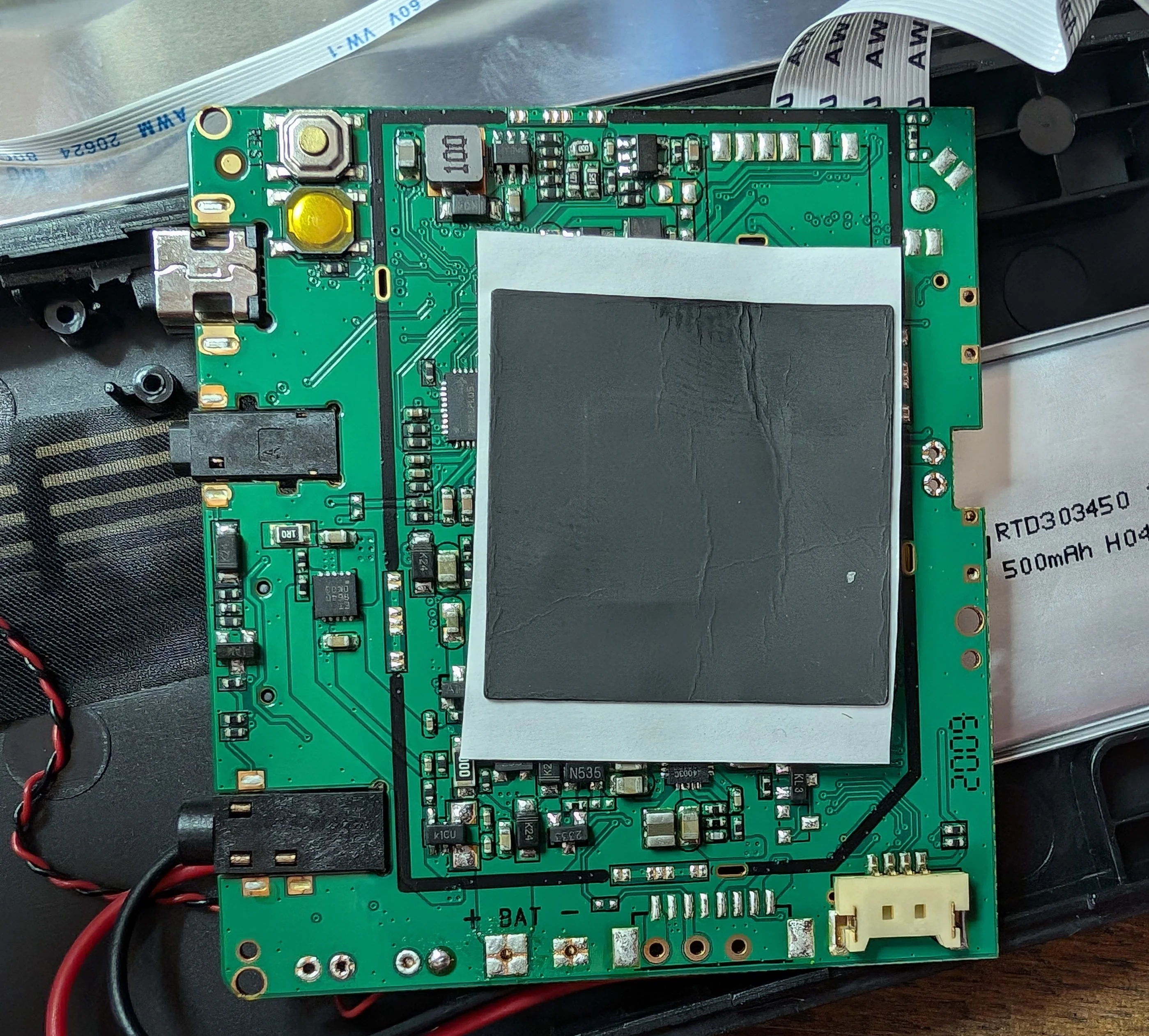 The 'rear' of the main PCB has a few unpopulated footprints and a flimsy heat-spreader.