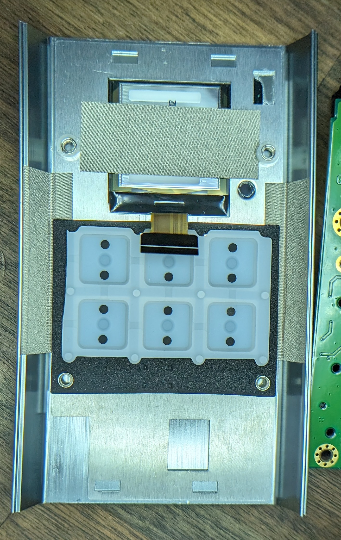 Interior of the front panel features button matrix and OLED.