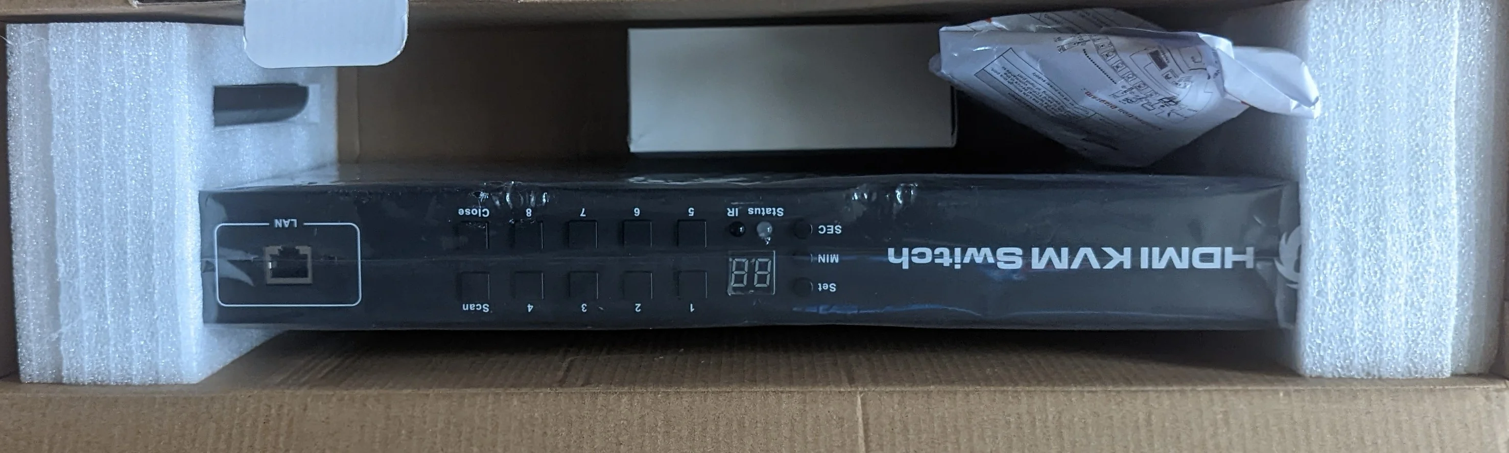 Picture showing the internal content of the shipping box. The KVM switch is secured with some foam.