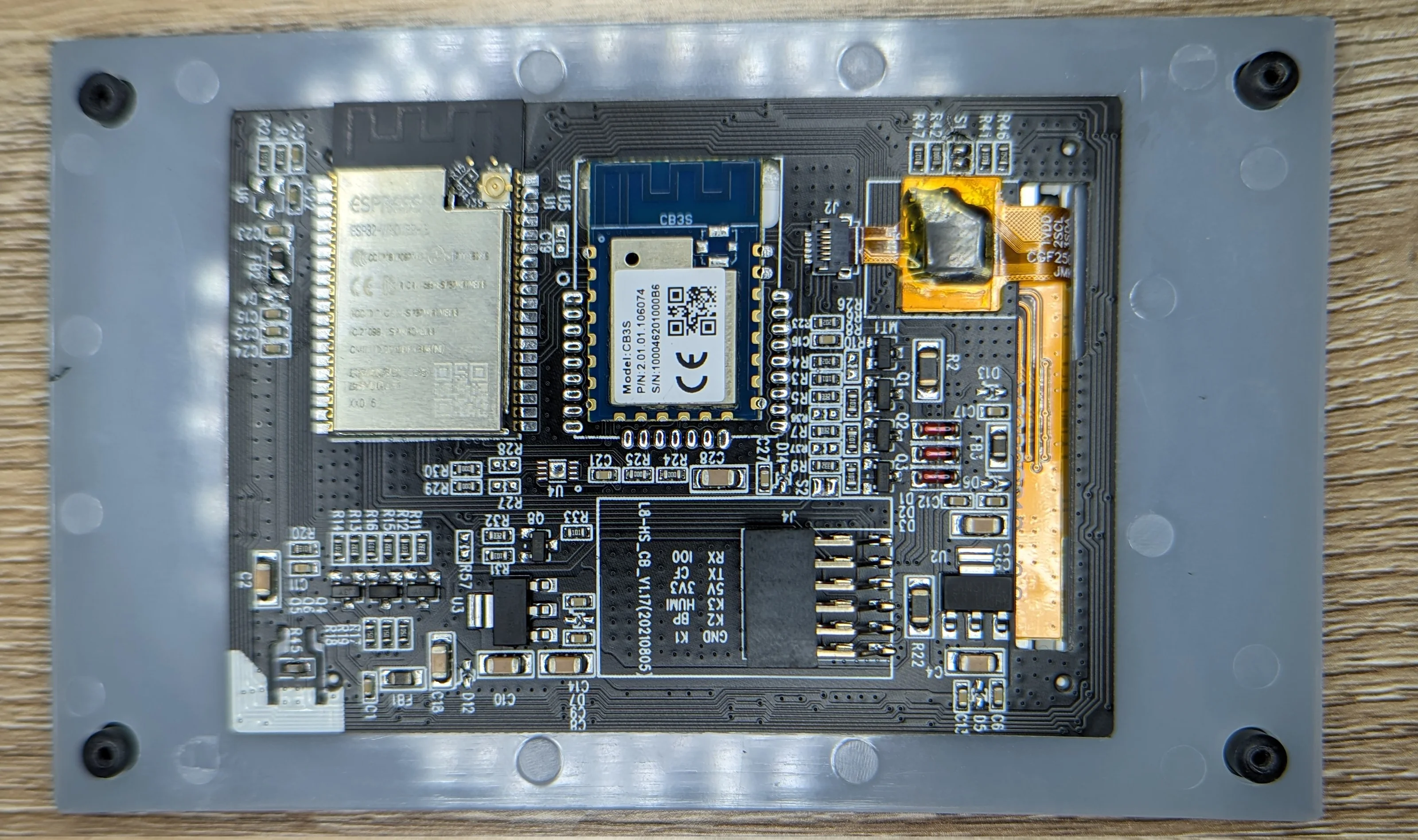Picture showing the internal circuit board of the low-voltage switch screen. There are two system on modules present. One is an ESP32 that runs the show and the other is a minimally connected TuYa module.