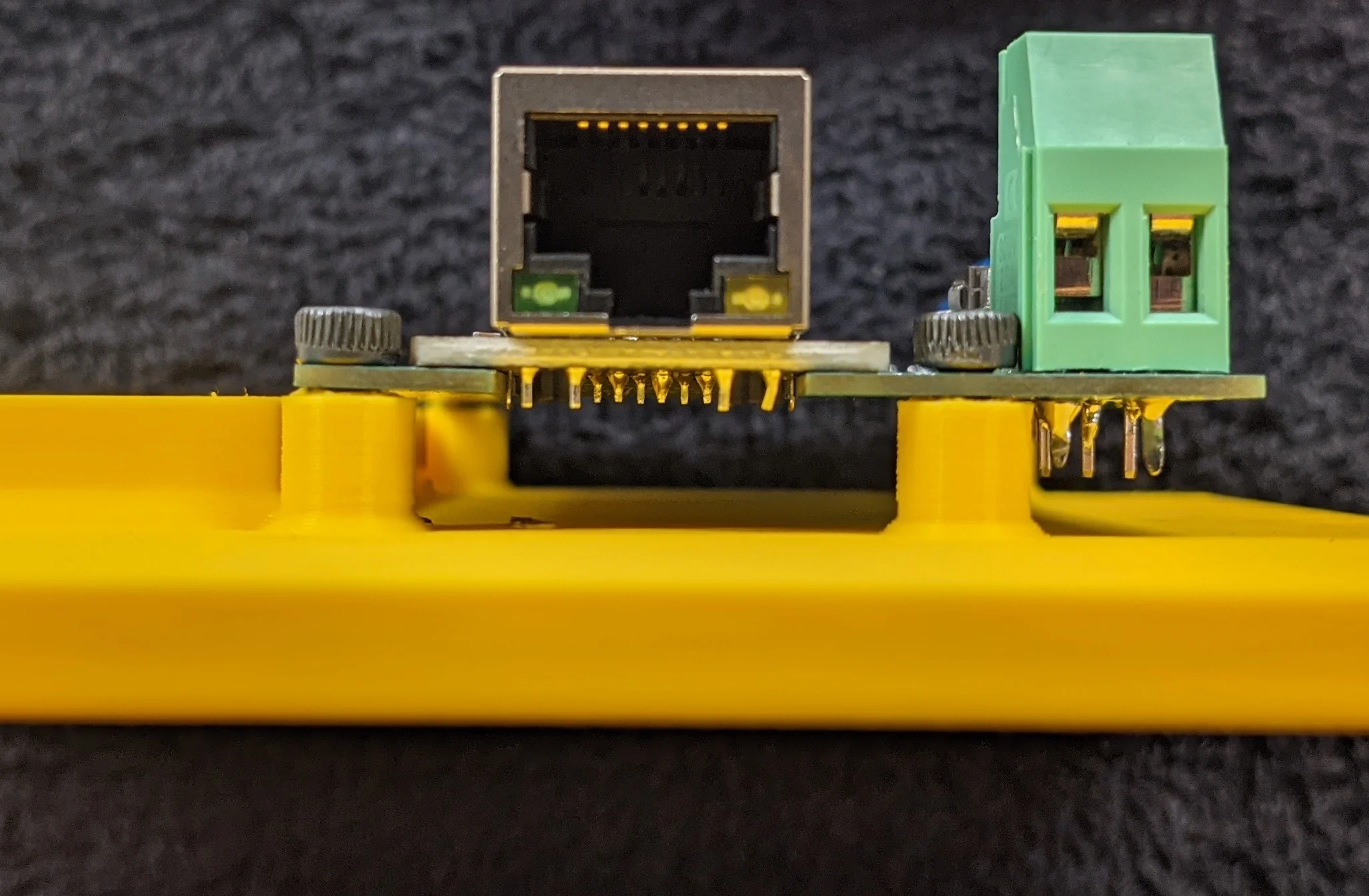 Picture showing assembly detail; the PCB should be attached to the base plate with screws and should be flush against the mounting posts.