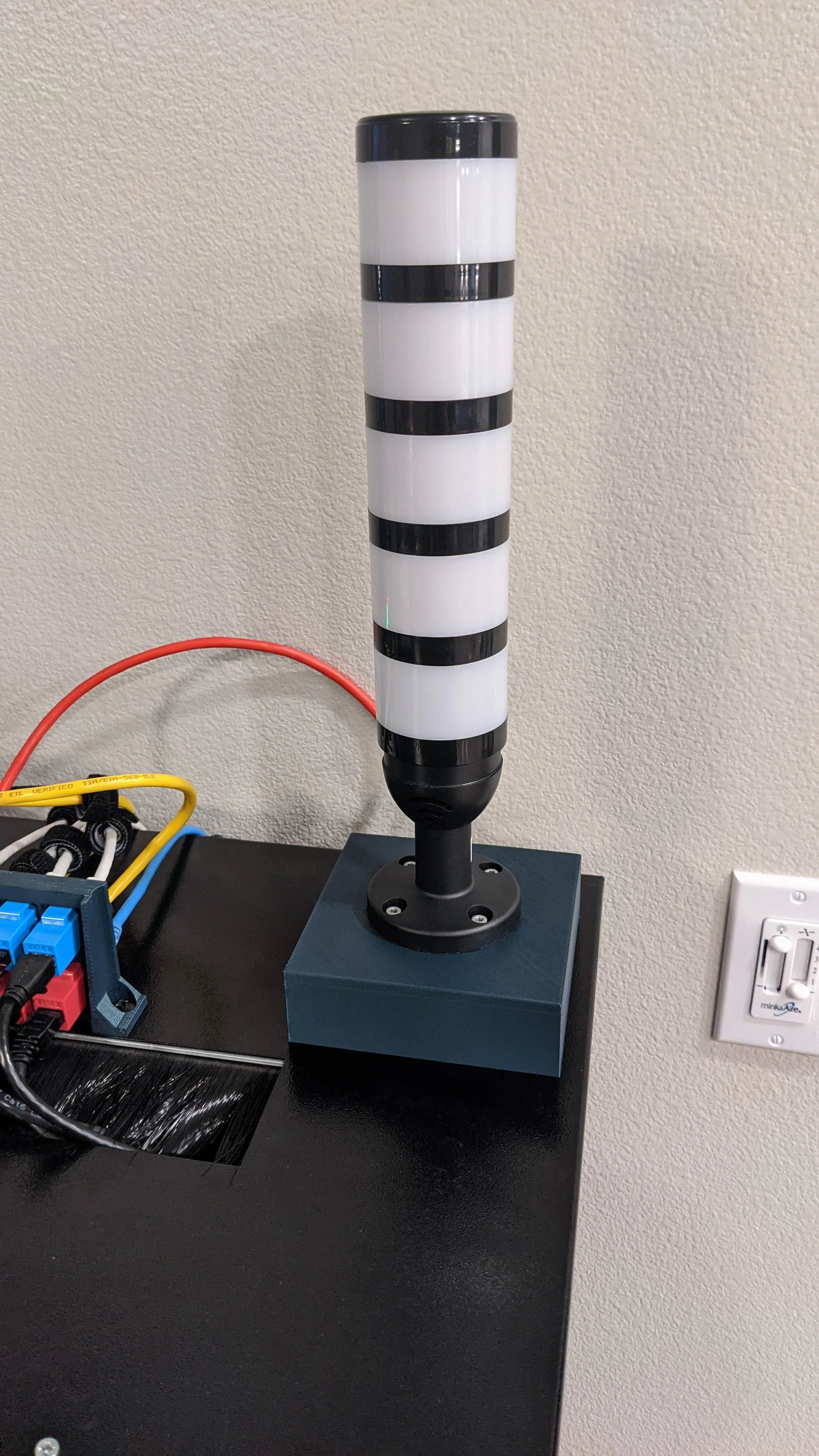 Picture showing assembled light attached to enclosure from the front. No individual light is powered up, they all have the same translucent white color.