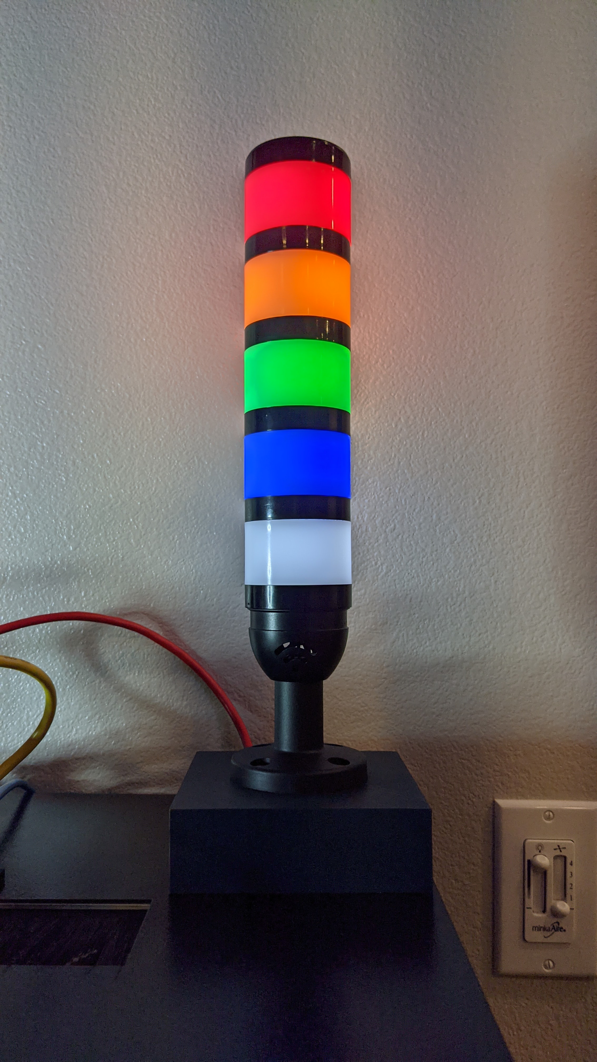 Picture showing assembled light attached to enclosure from the front. All 5 lights are lit.