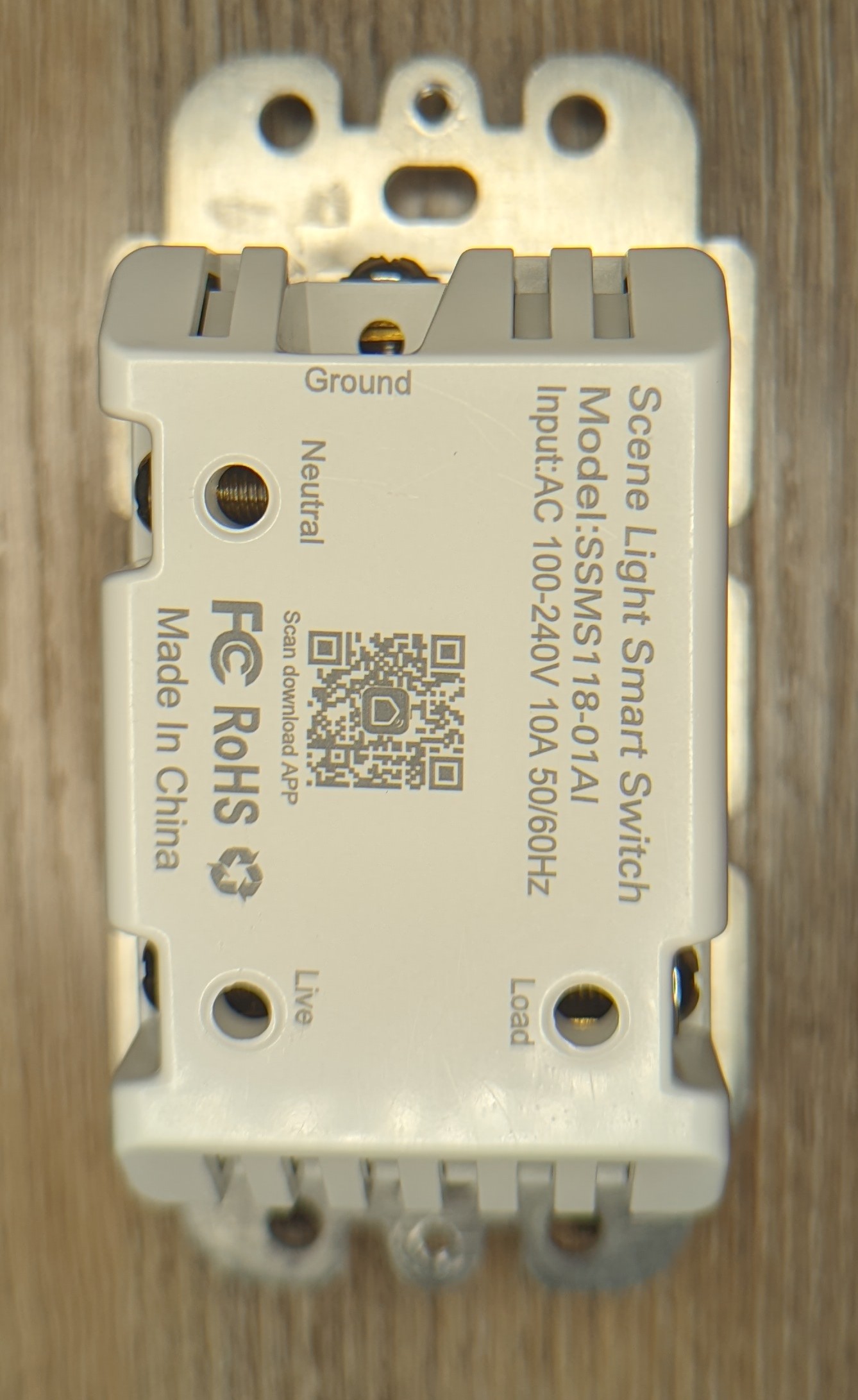 Picture of the switch lying on its front so the rear is visible. Product model number and other details are visible. No screws or other evidence that entry is gained from the rear.