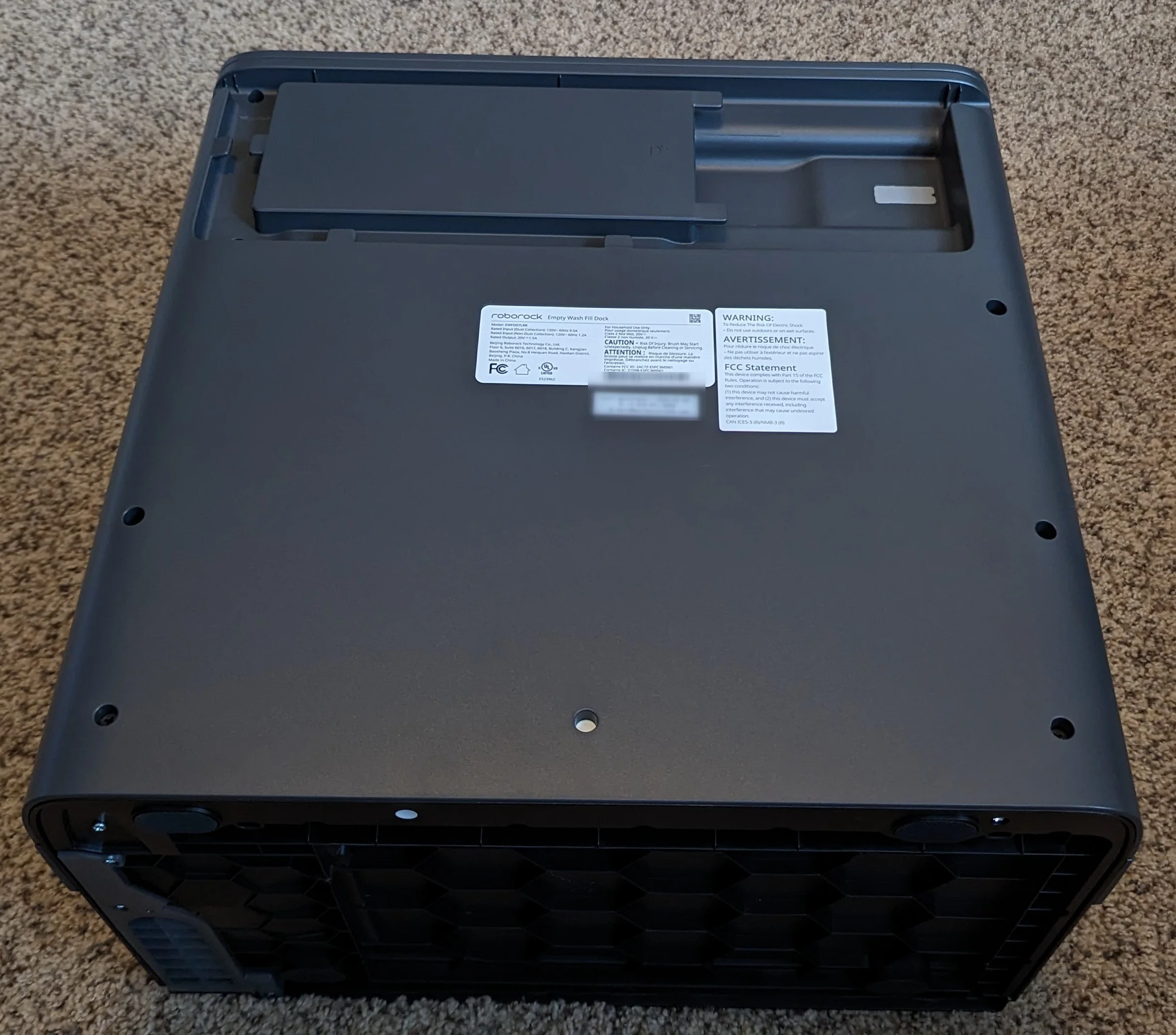 Note the white sticker covering the screw in the middle on the bottom.