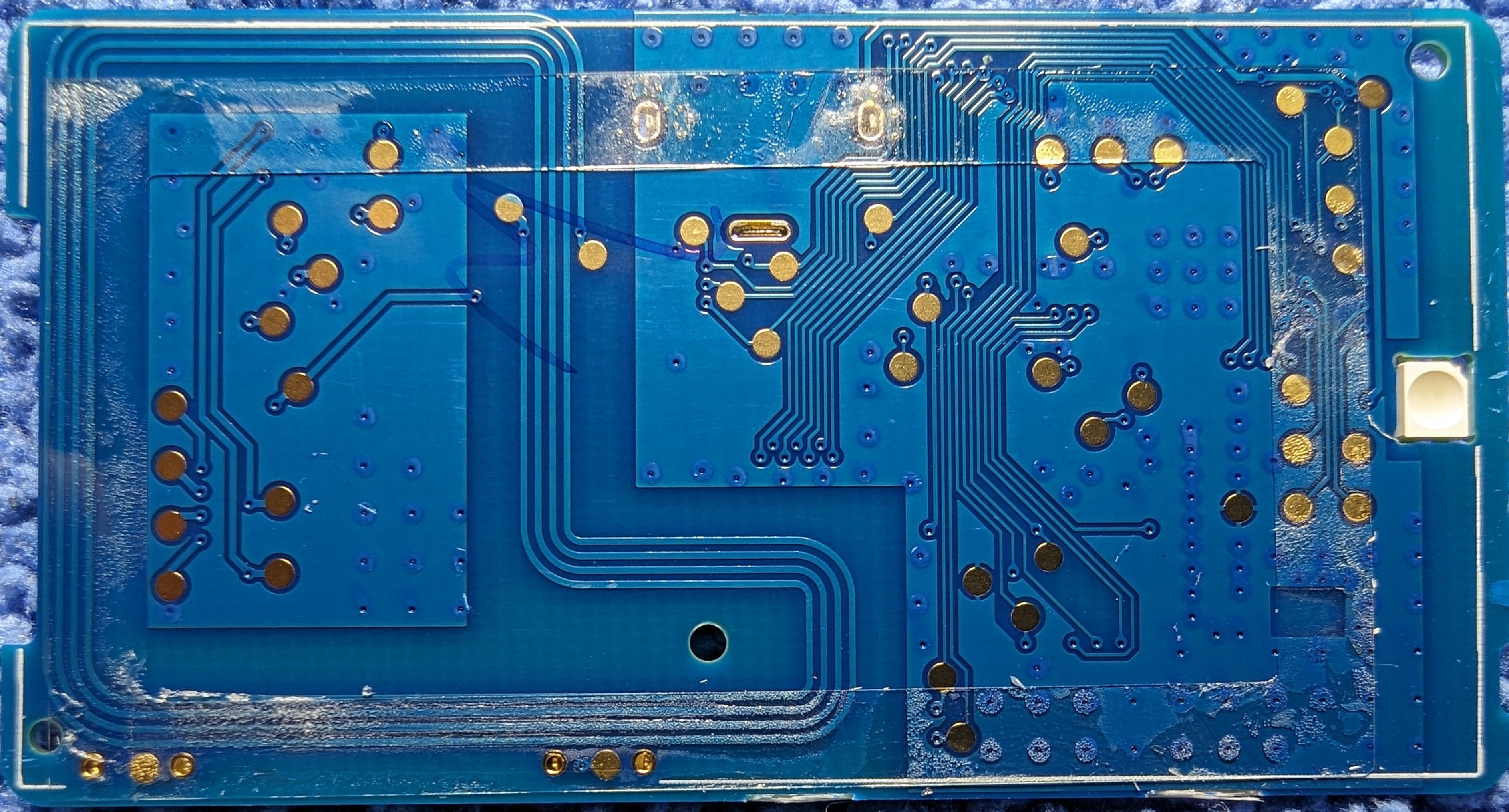 Closeup of the side of the PCB normally covered by the eInk panel. Note the thin layer of glue around the edge of the PCB used to hold the eInk panel in place.