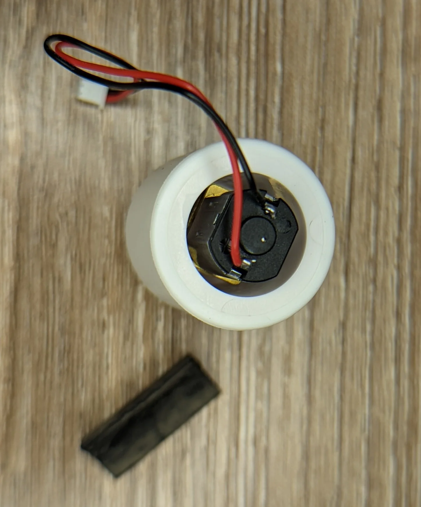 photo showing a hilariously small motor with a gearbox embedded in the drive roller mechanism.