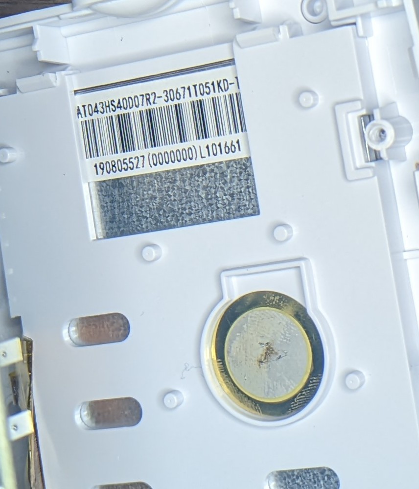 Photo showing a barcode on teh back of the LCD. Part of the label is obstructed