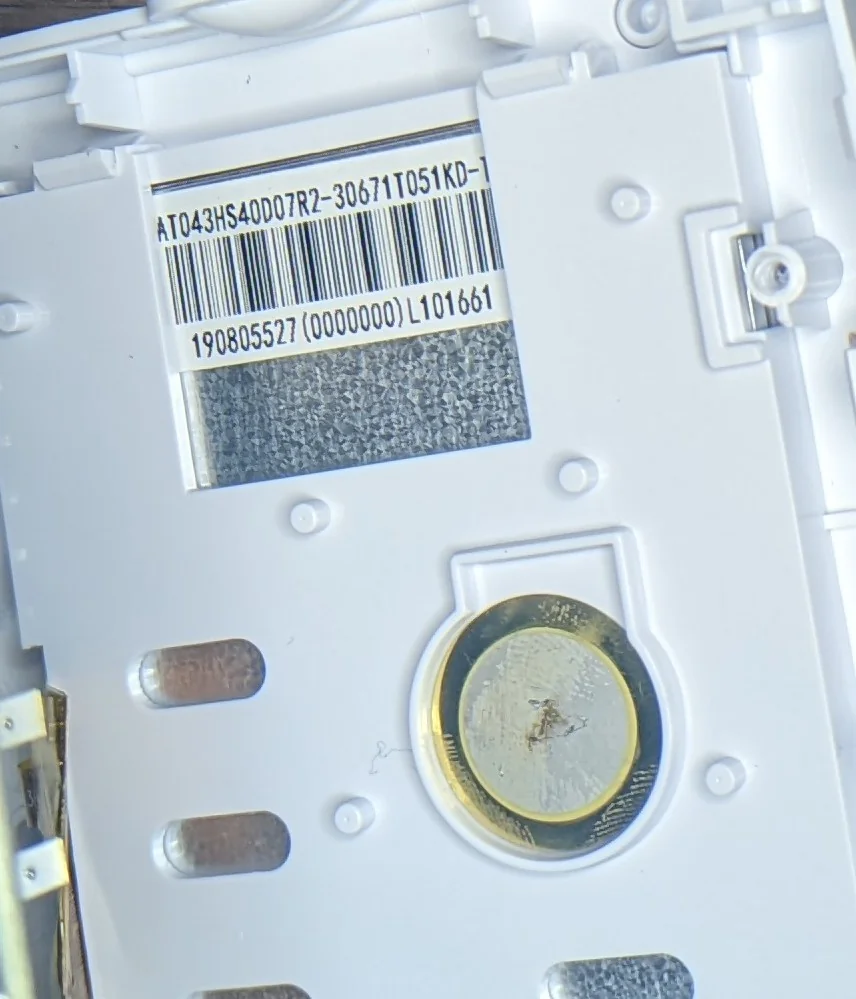 Photo showing a barcode on teh back of the LCD. Part of the label is obstructed