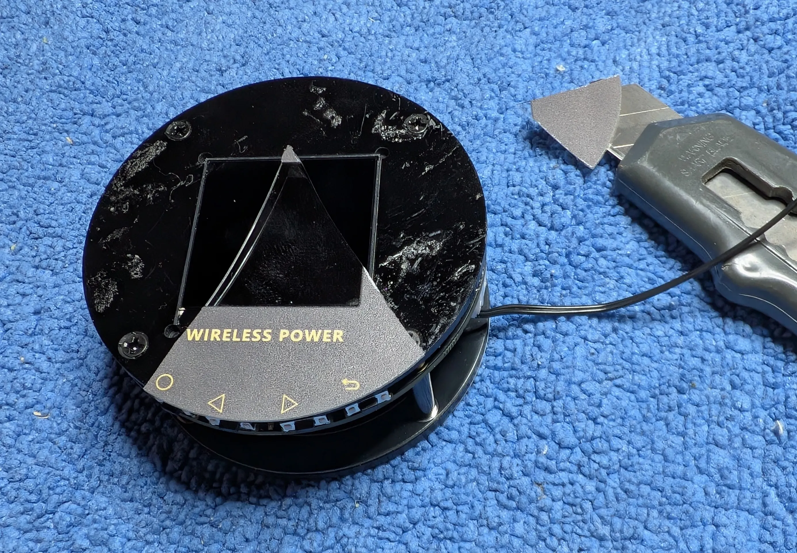 Three of the four screws can be seen here. The remaining screw is hiding beneath the remaining decal shard.