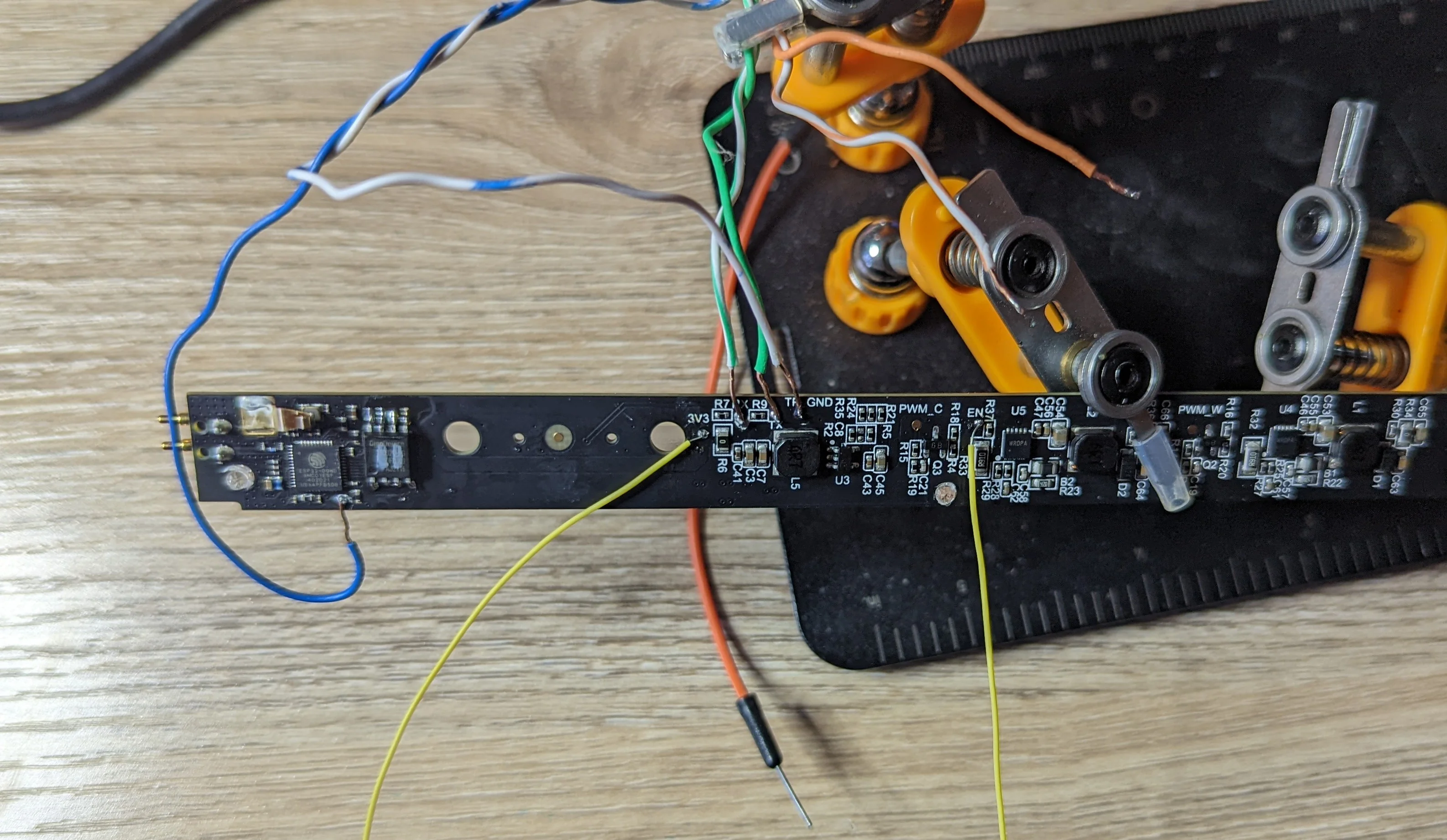 Picture showing the various jumper wires and other soldered connections needed to flash Tasmota to the PCB