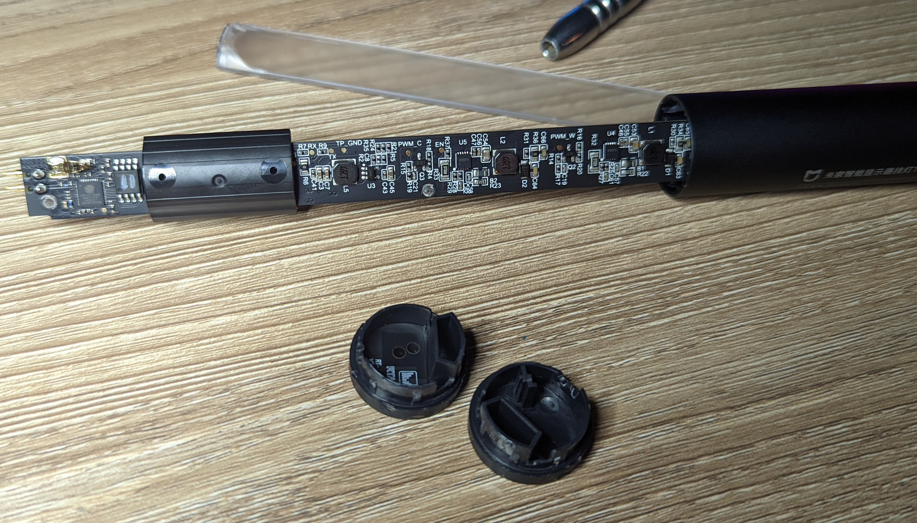 Photo showing a few of the lamp components removed and the primary PCB partially removed from the lamp body.